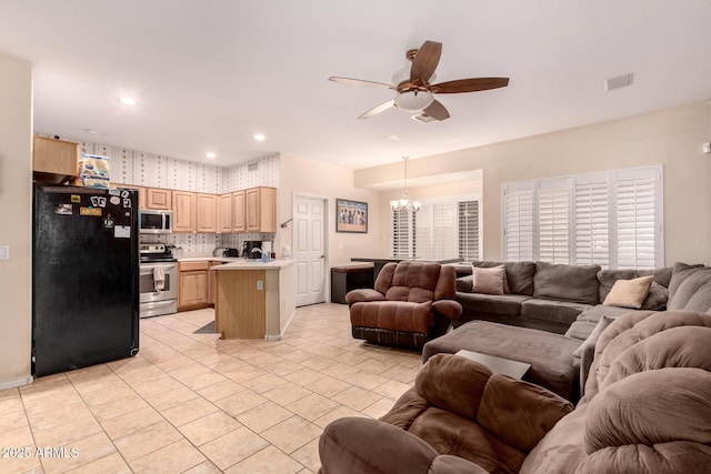 living room featuring ceiling fan with notable chandelier and light tile patterned floors