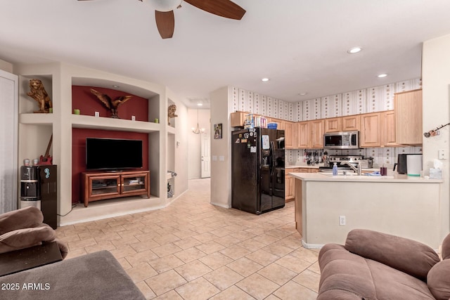 kitchen with sink, light brown cabinets, appliances with stainless steel finishes, kitchen peninsula, and ceiling fan