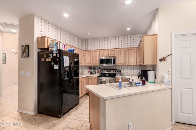 kitchen featuring sink, backsplash, stainless steel appliances, kitchen peninsula, and light brown cabinets