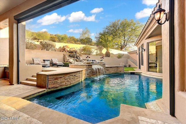 view of pool with a patio area and pool water feature