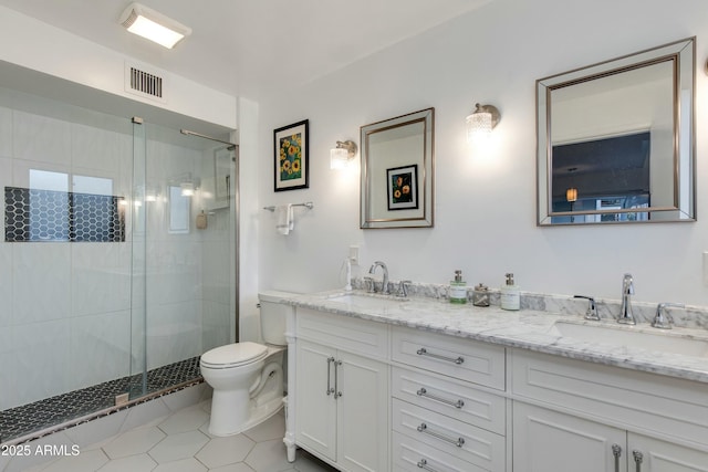 bathroom featuring vanity, toilet, a shower with shower door, and tile patterned flooring