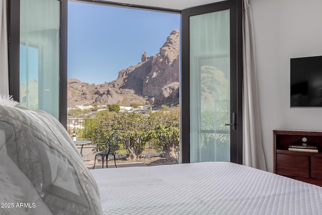 bedroom featuring a mountain view