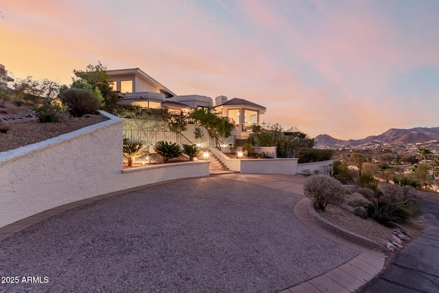 view of front facade featuring a mountain view and a patio area