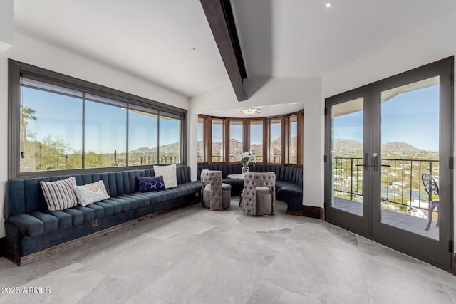 sunroom / solarium featuring french doors, a mountain view, and vaulted ceiling with beams