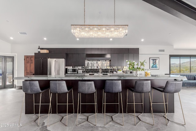 kitchen featuring a large island, sink, a breakfast bar, and appliances with stainless steel finishes