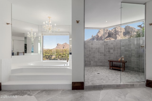 bathroom featuring a mountain view, a chandelier, and separate shower and tub