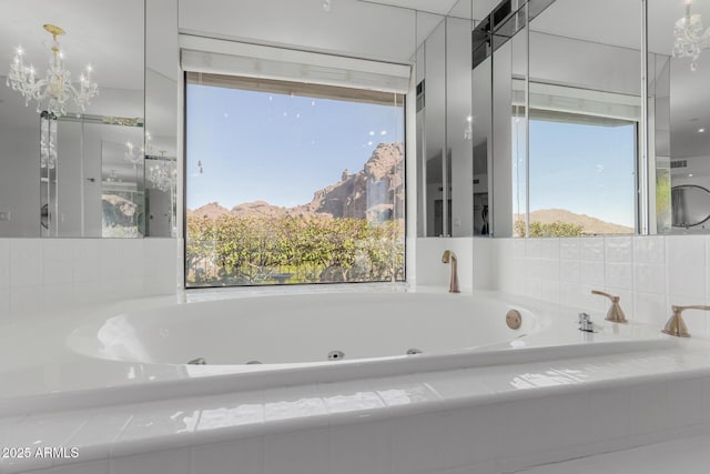 bathroom featuring a mountain view and a relaxing tiled tub