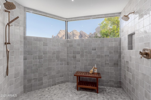 bathroom with a tile shower and a wealth of natural light