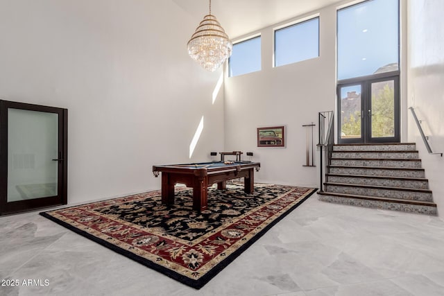 recreation room with pool table, a high ceiling, and a wealth of natural light