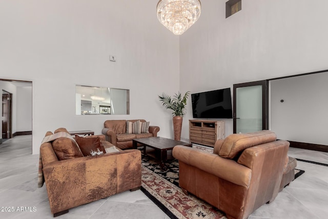 living room with a notable chandelier and a high ceiling