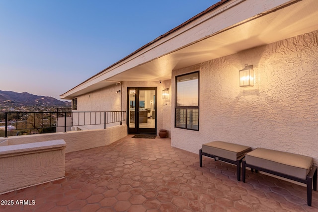 patio terrace at dusk with a mountain view