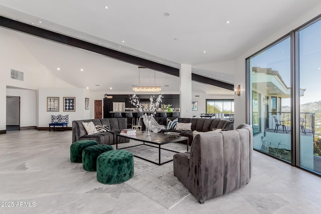 living room with beam ceiling and high vaulted ceiling