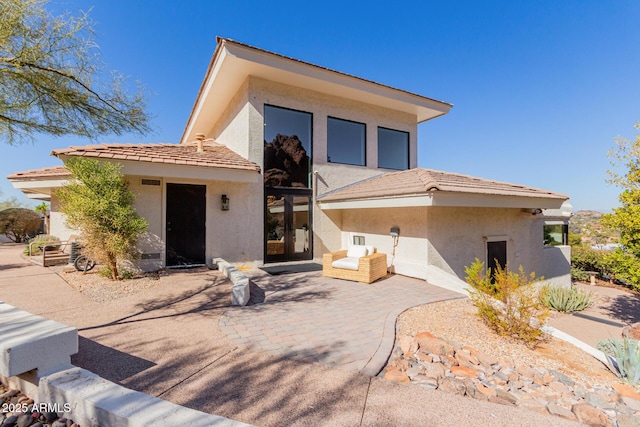 rear view of property featuring a patio