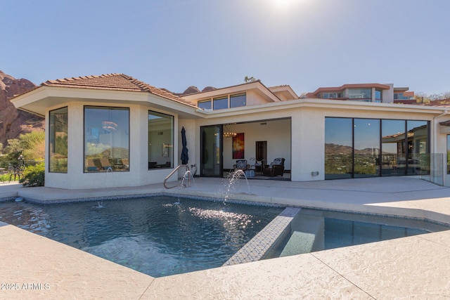 rear view of property featuring a patio area