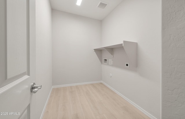 laundry room featuring hookup for an electric dryer and light wood-type flooring