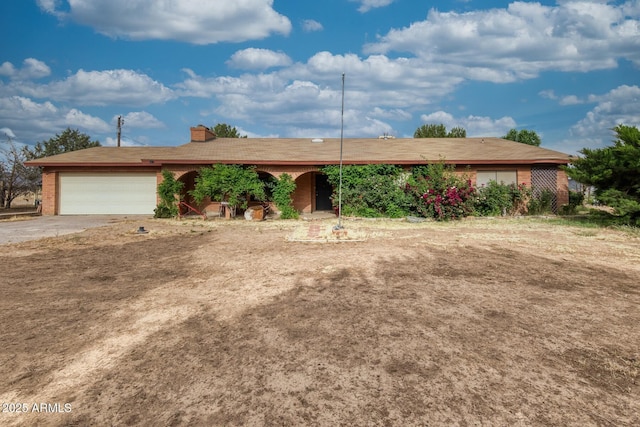 11870 N Fort Grant Rd, Willcox, AZ 85643 - ranch-style house with a garage, concrete driveway, and a chimney
