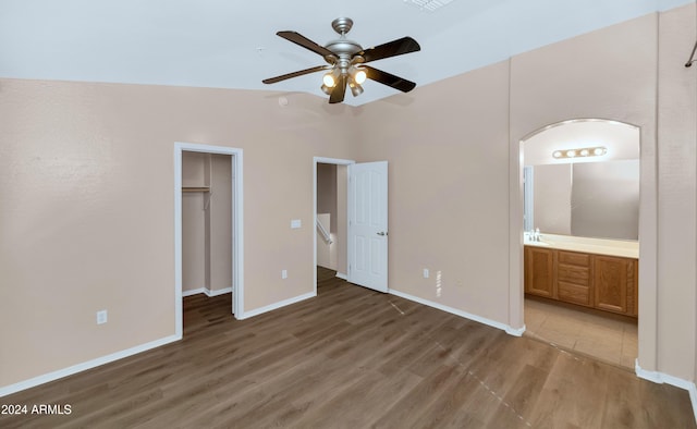 17365 N Cave Creek Rd Unit 116, Phoenix, AZ 85032 - unfurnished bedroom with wood finished floors, a walk in closet, ensuite bath, and baseboards