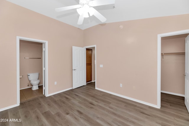 17365 N Cave Creek Rd Unit 116, Phoenix, AZ 85032 - unfurnished bedroom featuring a walk in closet, wood finished floors, a closet, ensuite bath, and baseboards