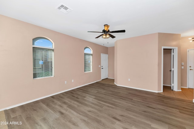 empty room featuring wood-type flooring and ceiling fan