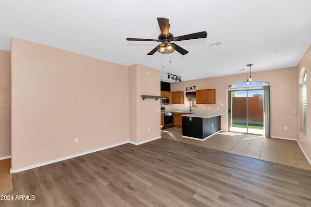 17365 N Cave Creek Rd Unit 116, Phoenix, AZ 85032 - unfurnished living room with wood finished floors, ceiling fan, and baseboards