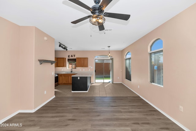 17365 N Cave Creek Rd Unit 116, Phoenix, AZ 85032 - unfurnished living room featuring ceiling fan, a sink, wood finished floors, and baseboards