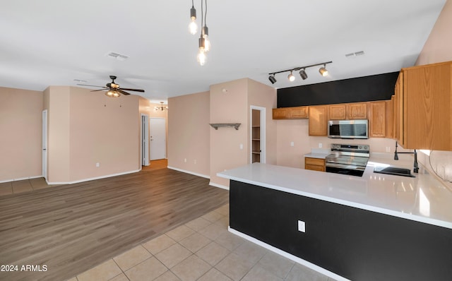 17365 N Cave Creek Rd Unit 116, Phoenix, AZ 85032 - kitchen featuring stainless steel appliances, a sink, ceiling fan, light countertops, and rail lighting