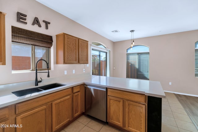 17365 N Cave Creek Rd Unit 116, Phoenix, AZ 85032 - kitchen with dishwasher, a sink, a peninsula, light countertops, and light tile patterned floors