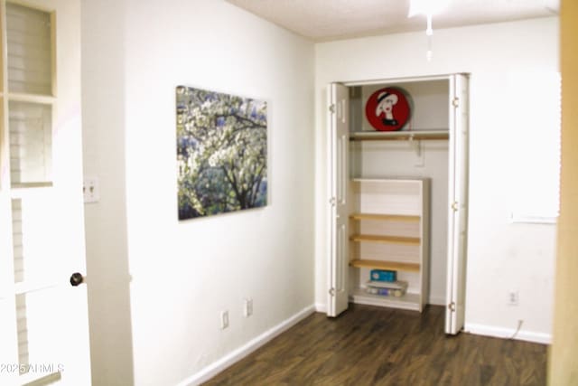 bedroom with dark wood-type flooring