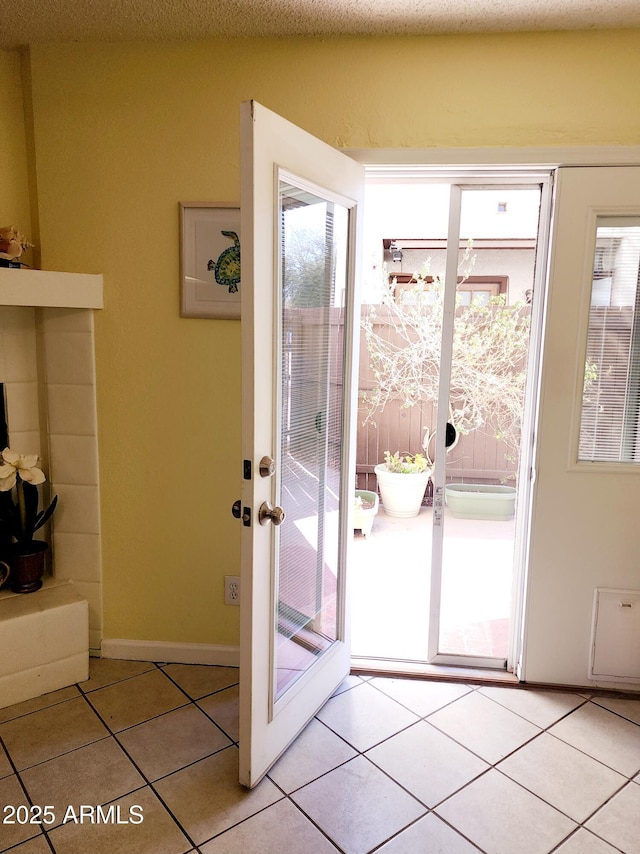 doorway to outside featuring light tile patterned flooring and french doors