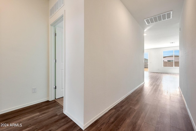 hallway with dark hardwood / wood-style floors