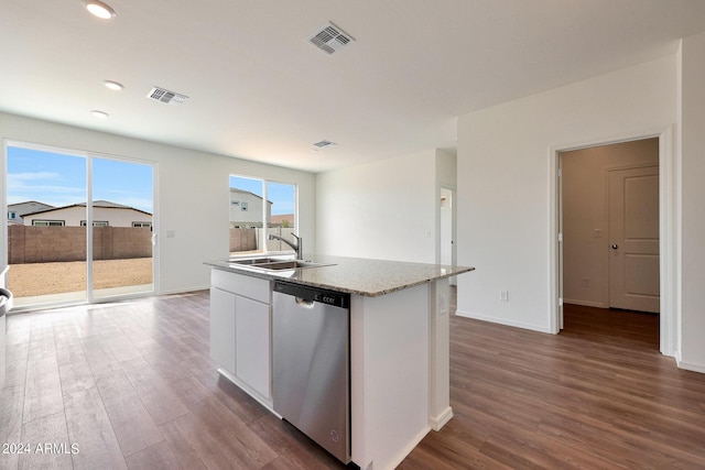 kitchen featuring stainless steel dishwasher, sink, white cabinetry, dark wood-type flooring, and an island with sink