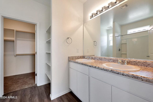 bathroom with a shower, hardwood / wood-style flooring, and vanity