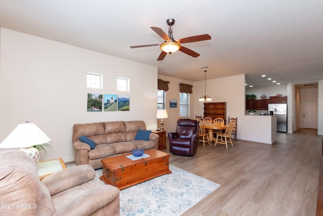 living room featuring hardwood / wood-style flooring and ceiling fan