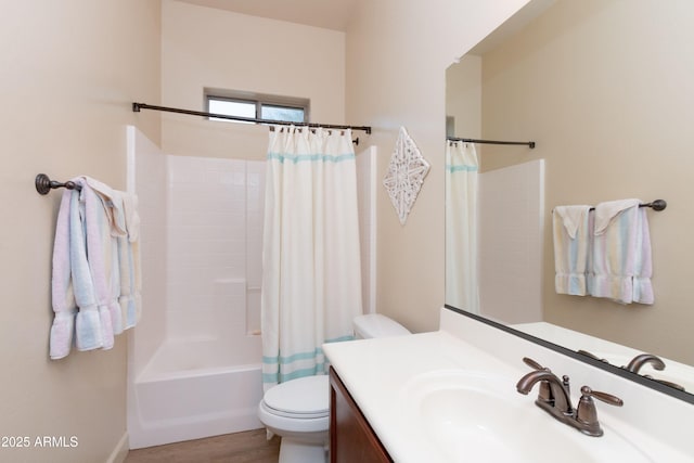 full bathroom featuring hardwood / wood-style flooring, vanity, shower / tub combo, and toilet