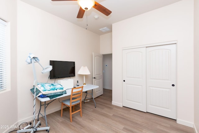 home office with ceiling fan and light wood-type flooring