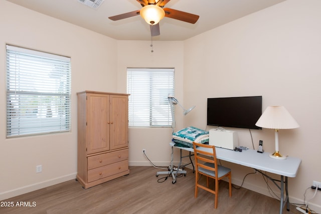 office area with hardwood / wood-style floors, a wealth of natural light, and ceiling fan