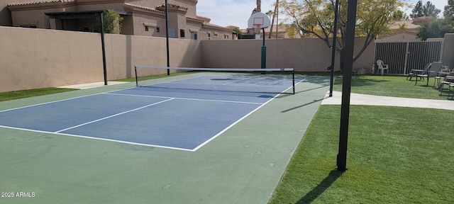 view of sport court featuring a lawn