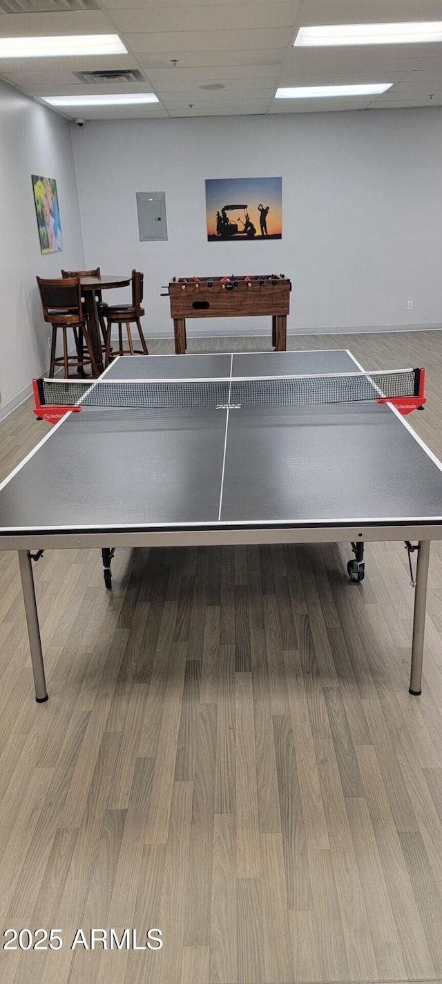 game room featuring hardwood / wood-style flooring and a drop ceiling