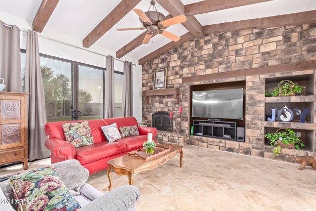 living room with ceiling fan, a fireplace, built in shelves, and lofted ceiling with beams