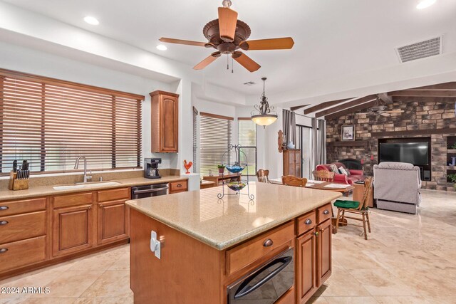 kitchen featuring light tile patterned flooring, sink, and a kitchen island