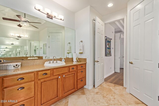 bathroom with ceiling fan, tile patterned flooring, and vanity