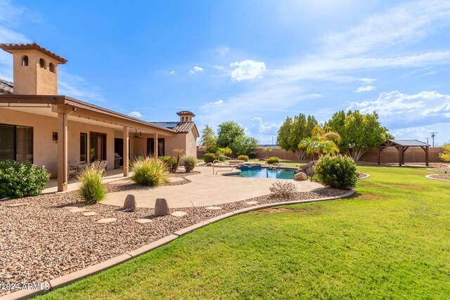 view of swimming pool featuring a patio area and a yard