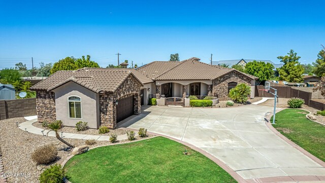 view of front of home with a garage and a front lawn