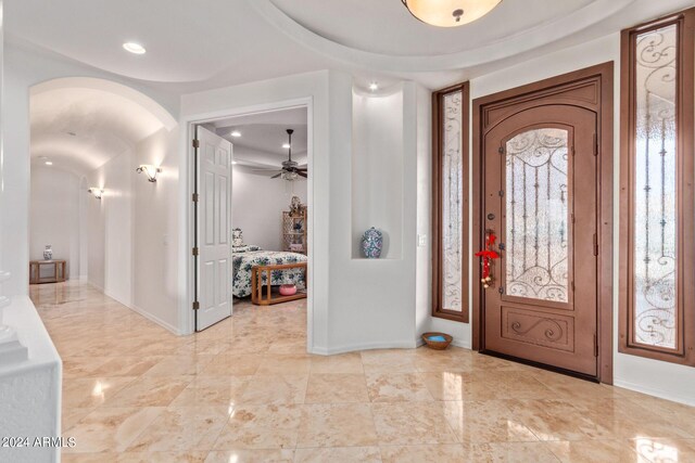 entryway featuring ceiling fan and light tile patterned flooring