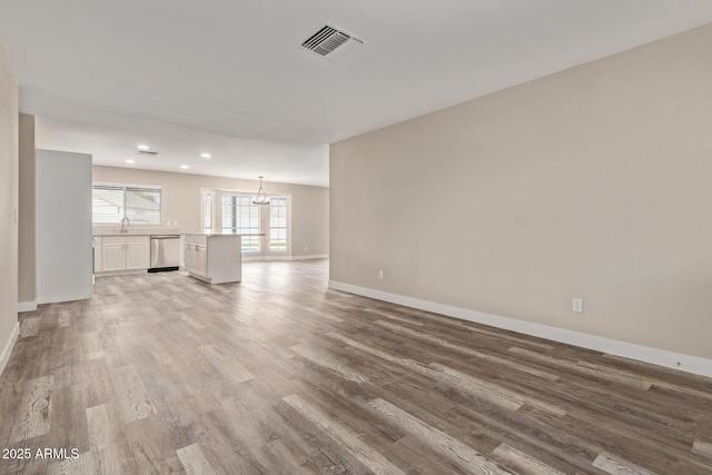 1416 W Highland St, Chandler, AZ 85224 - unfurnished living room featuring a chandelier, baseboards, light wood-style flooring, and recessed lighting