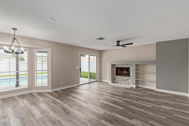 1416 W Highland St, Chandler, AZ 85224 - unfurnished living room with wood finished floors, a stone fireplace, and baseboards