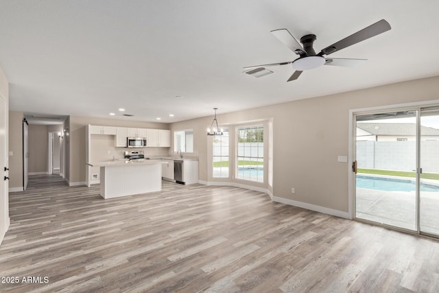 1416 W Highland St, Chandler, AZ 85224 - unfurnished living room with light wood finished floors, baseboards, recessed lighting, and ceiling fan