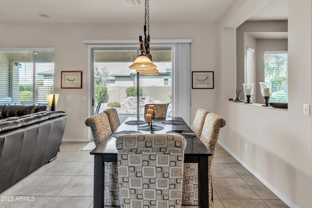 dining room with light tile patterned flooring, visible vents, and baseboards