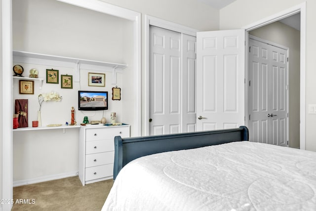 carpeted bedroom with a closet and baseboards