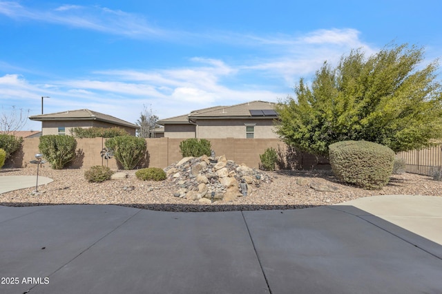 exterior space with stucco siding, a patio area, and fence private yard